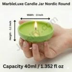 A person’s hand holding a shallow, lime green Nordic Round candle jar made from solid marble powder, featuring a wide circular design and a lit candle flame graphic.
