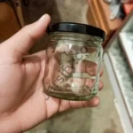 Curved waist-shaped glass jar with secure lid, perfect for storing honey, jam, achar, and other kitchen items.